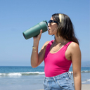 girl drinking from a green splitflask